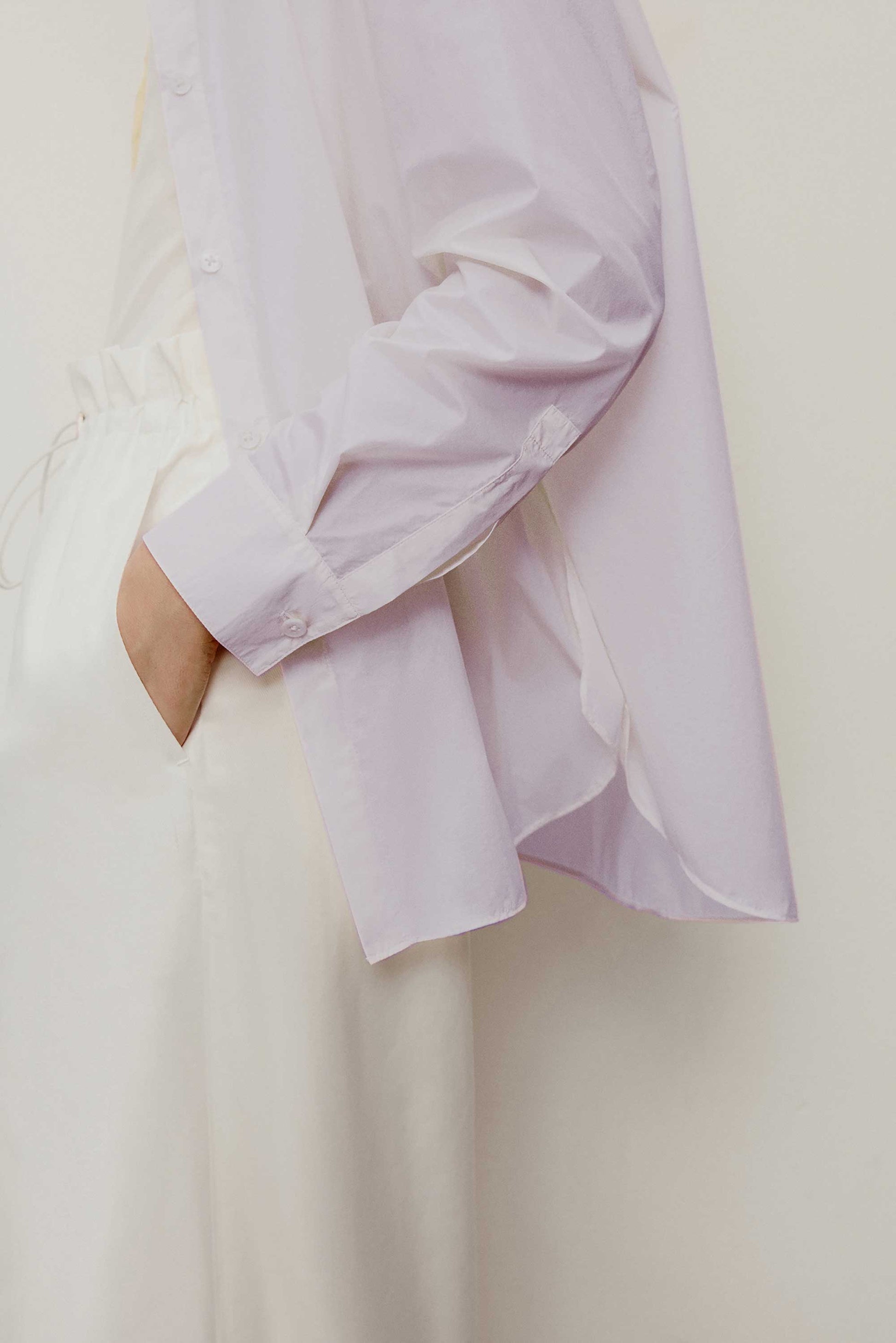 side detail of the light purple shirt. showing the long sleeve details 