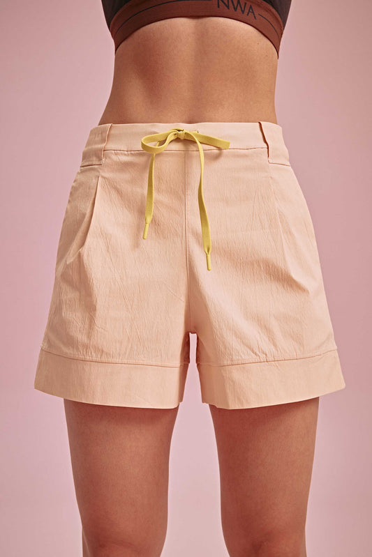closeup shot of the warm yellow shorts with yellow knot