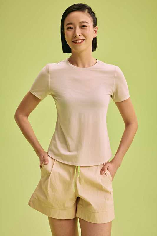 a woman wearing cream top and light yellow shorts