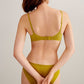 back of woman in green bra and brief