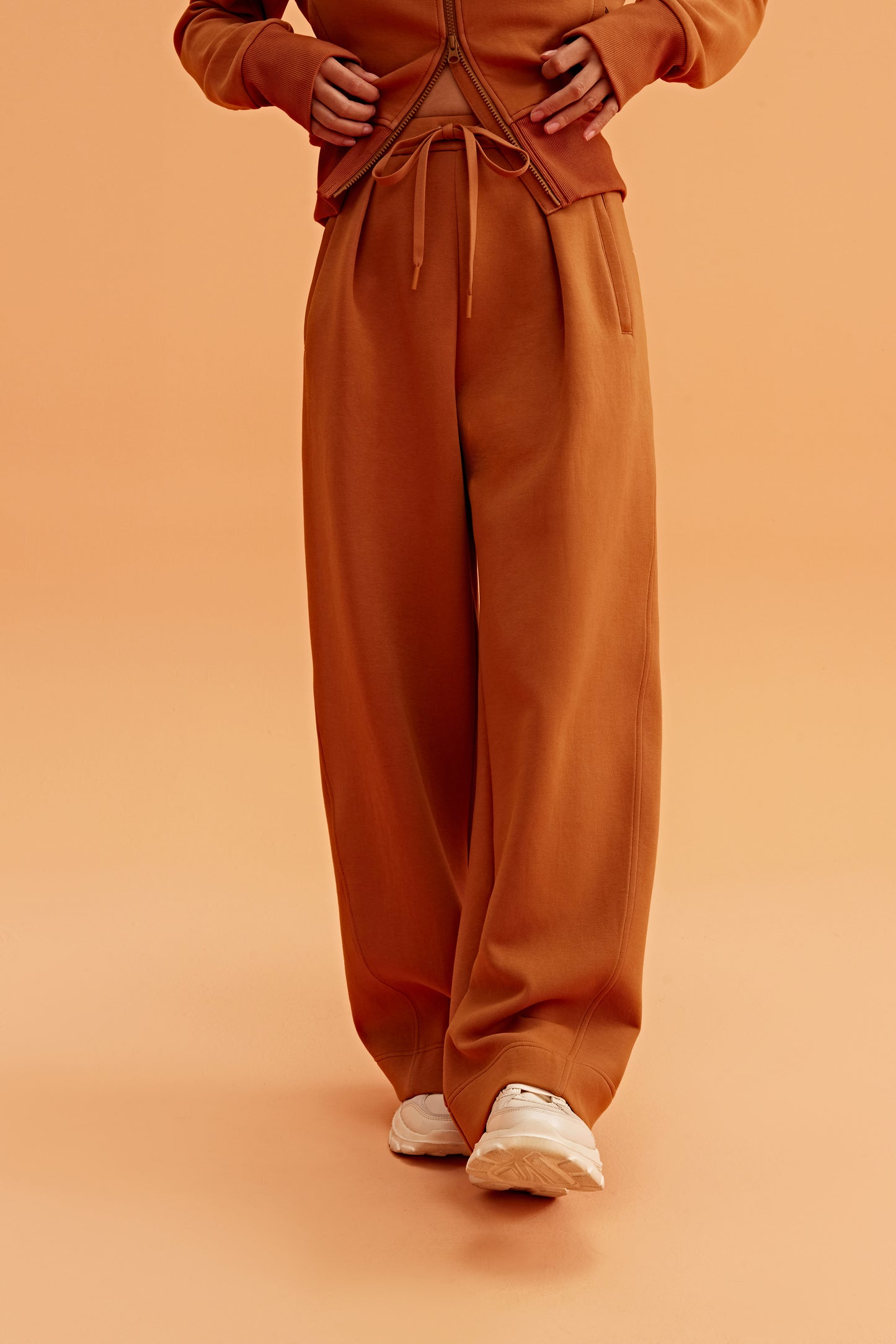 woman in caramel wide leg pants