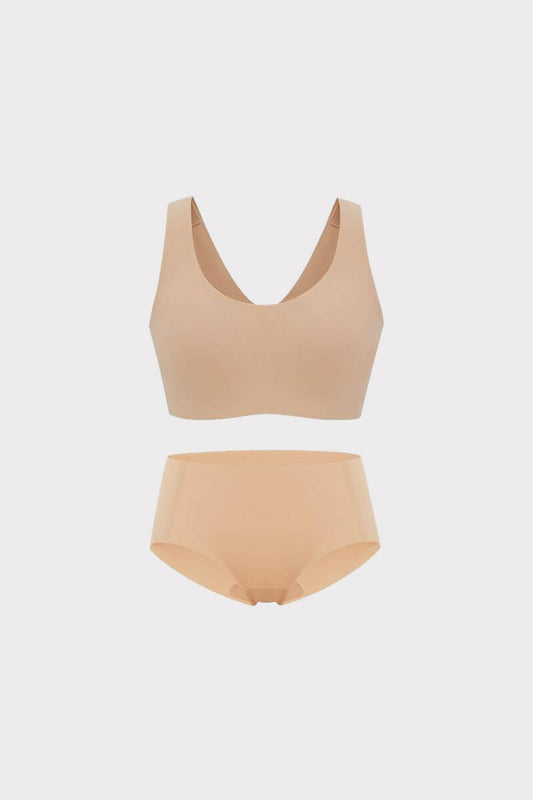A beige Barely Zero Classic Bra and matching Mid-Waist Brief set displayed against a soft gray background.