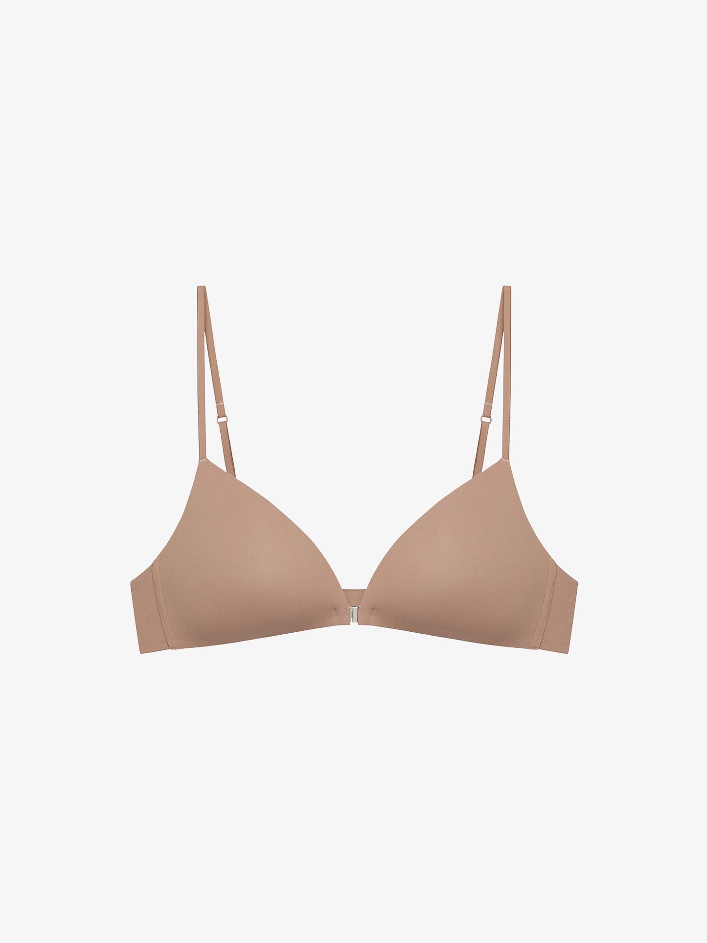 Flat lay of beige bra on a light gray background.