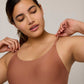 Woman wearing rust-colored tank bra