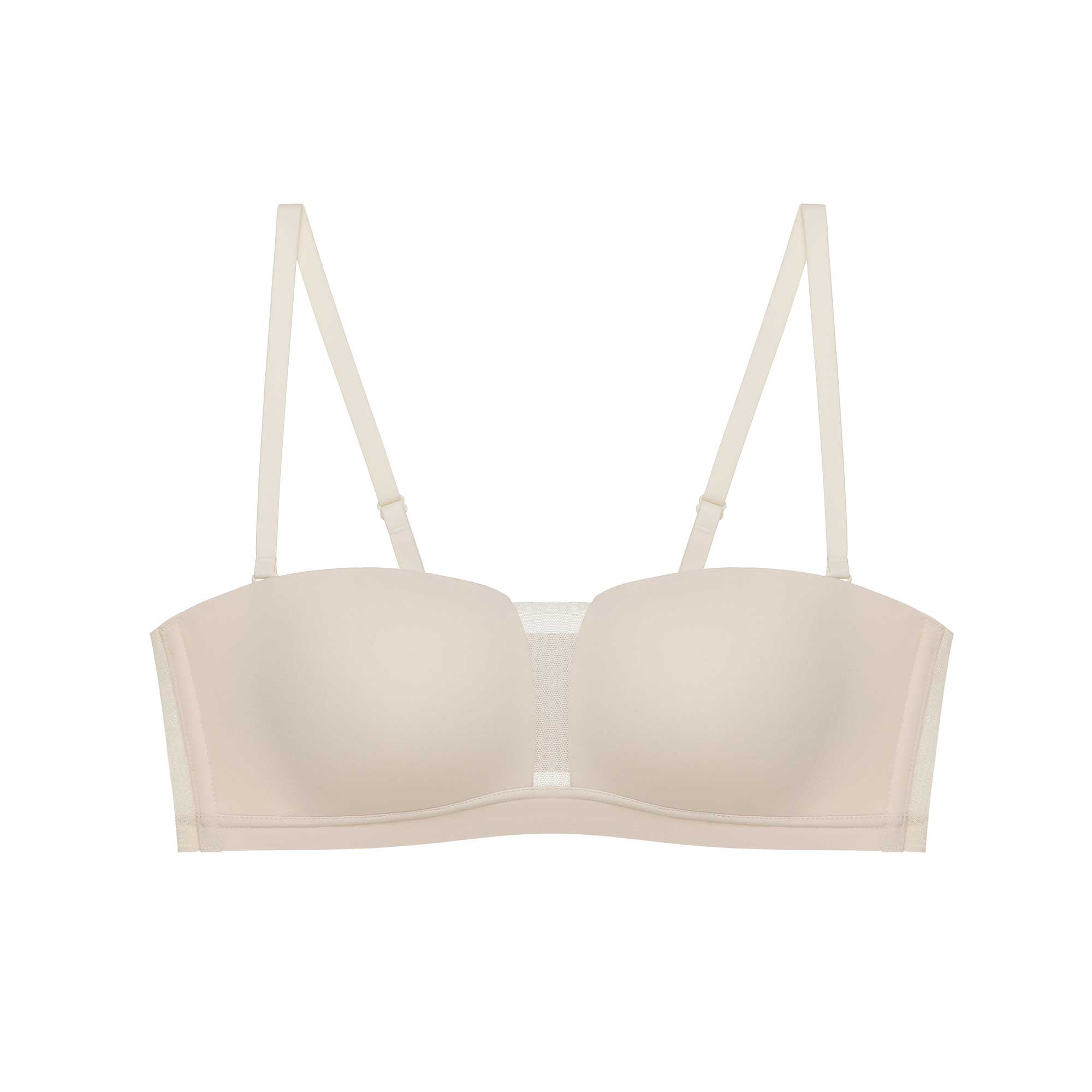 Flat lay image of a beige bandeau bra with mesh insert and removable straps