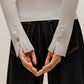 the gray silky wool zip-up cardigan and black pants from back