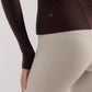 close up of a brown mousse long sleeve sports top and grey leggings