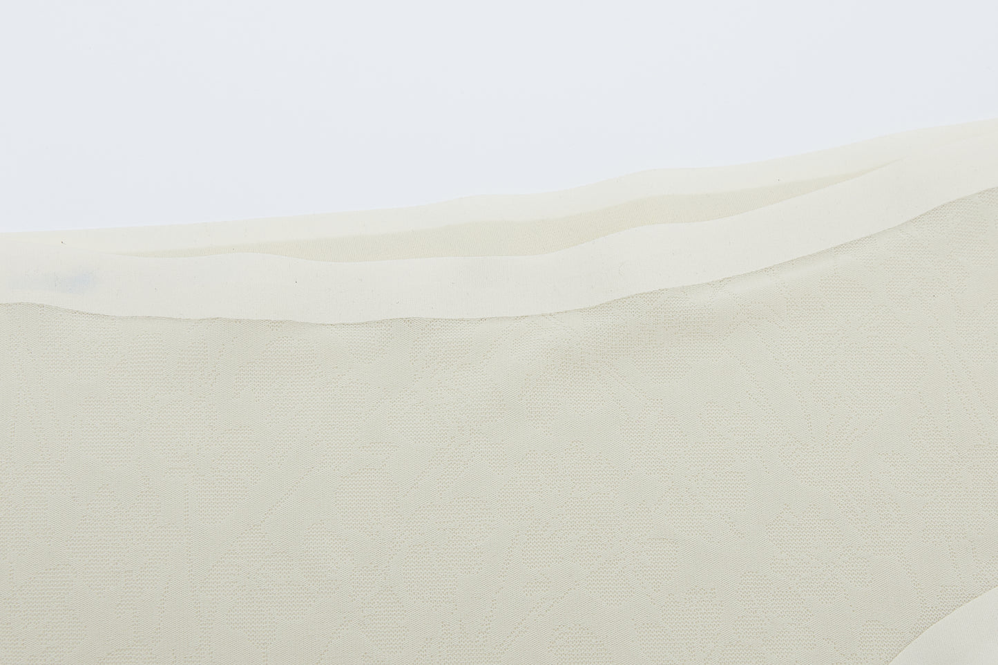 Close-up of off-white lace fabric