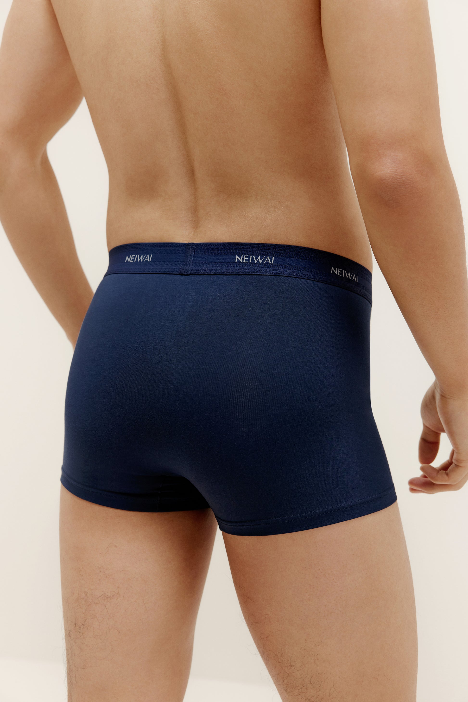 A man wearing navy brief from back