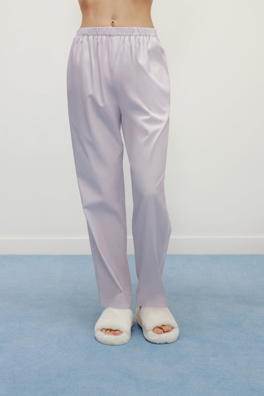 a person wearing purple pants and white slippers