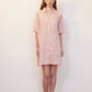 woman with pink pajama dress with white sketches