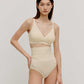 woman in cream color cross over bra and high waist brief