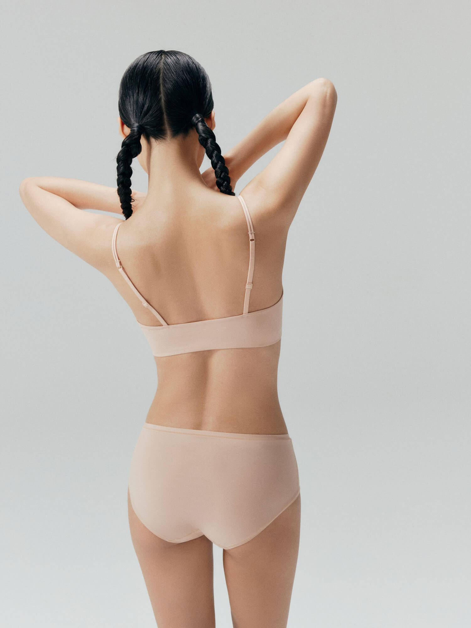 Back view of model wearing nude bra and brief set