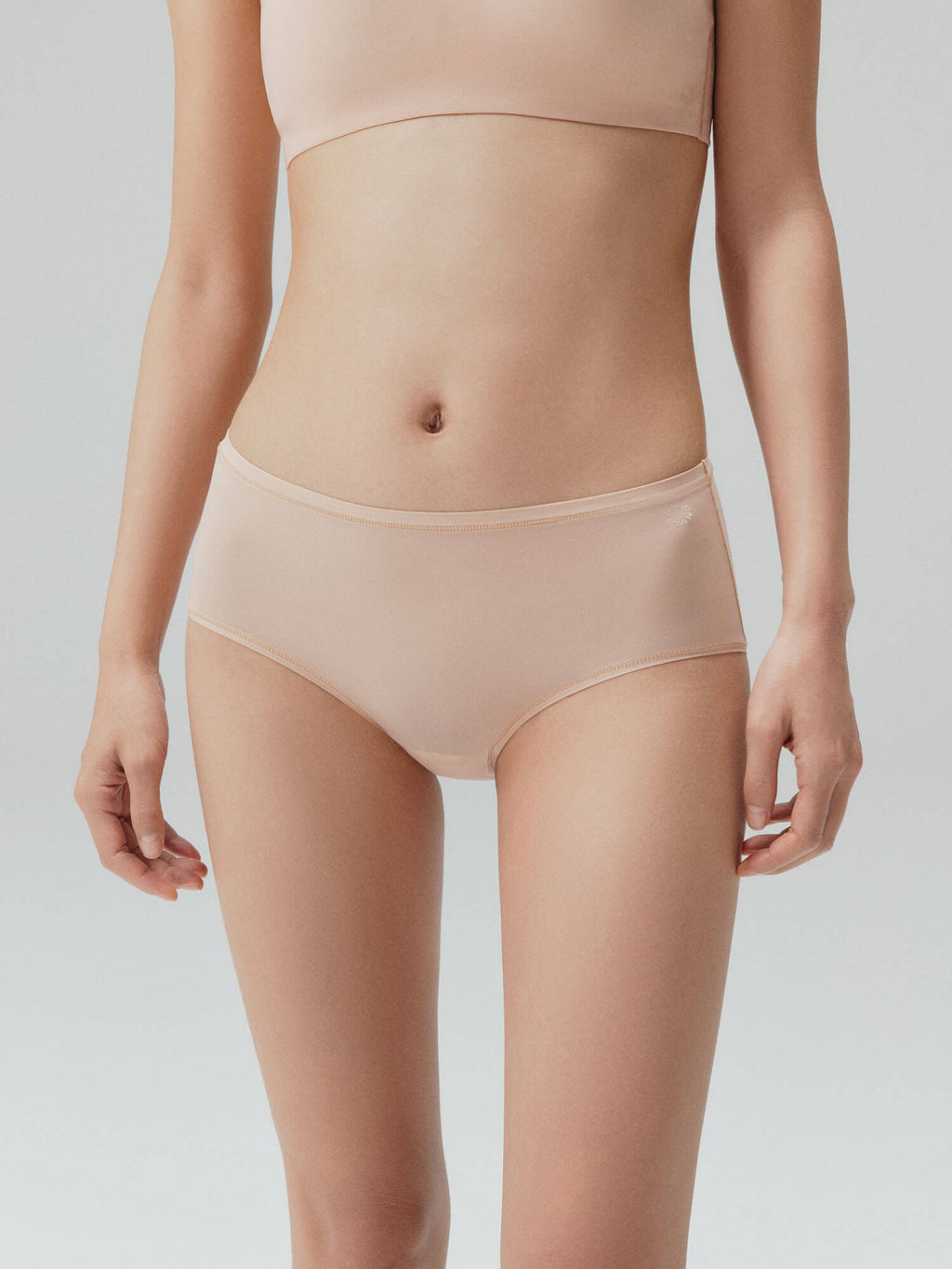 Model wearing nude mid-waist briefs