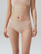 Model wearing nude mid-waist briefs