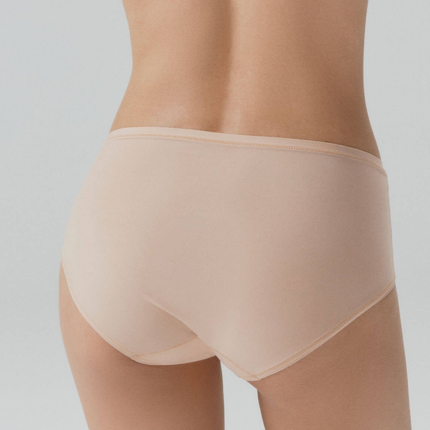 Beige shapewear garment on a plain background