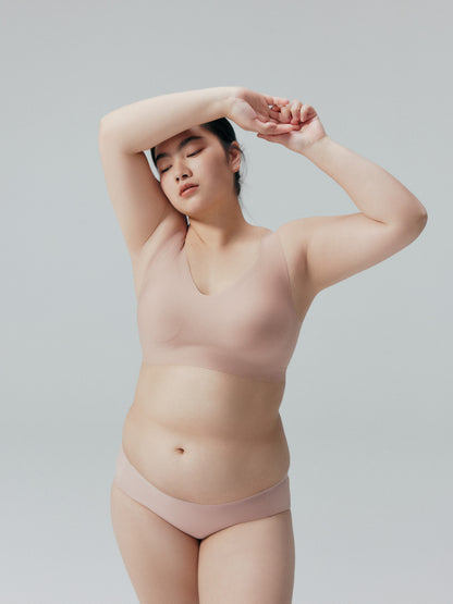 Model wearing a nude bra and brief set.