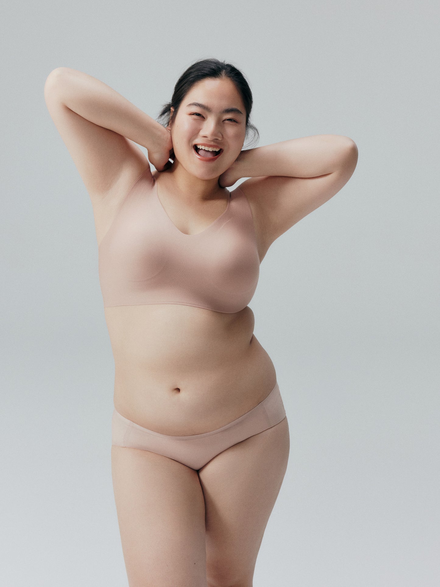 Model wearing a nude beige bra and brief set.