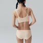 Back view of model wearing cream colored bra and brief set.