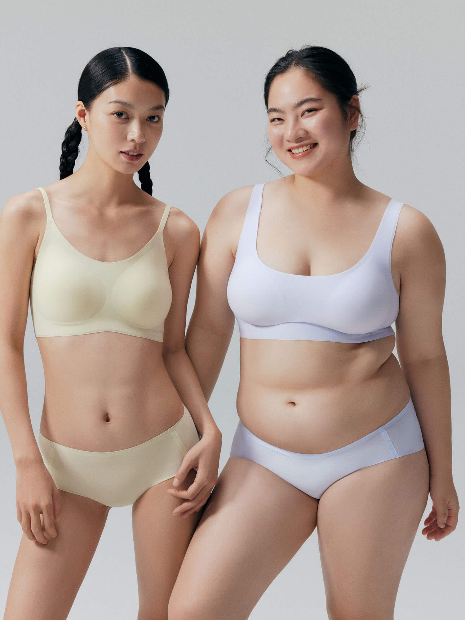 Two models wearing Barely Zero bra and brief set.