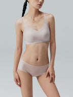 Model wearing nude colored bra and brief set.