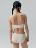Back side of model wearing white bandeau bra and briefs. Eggwhite color.
