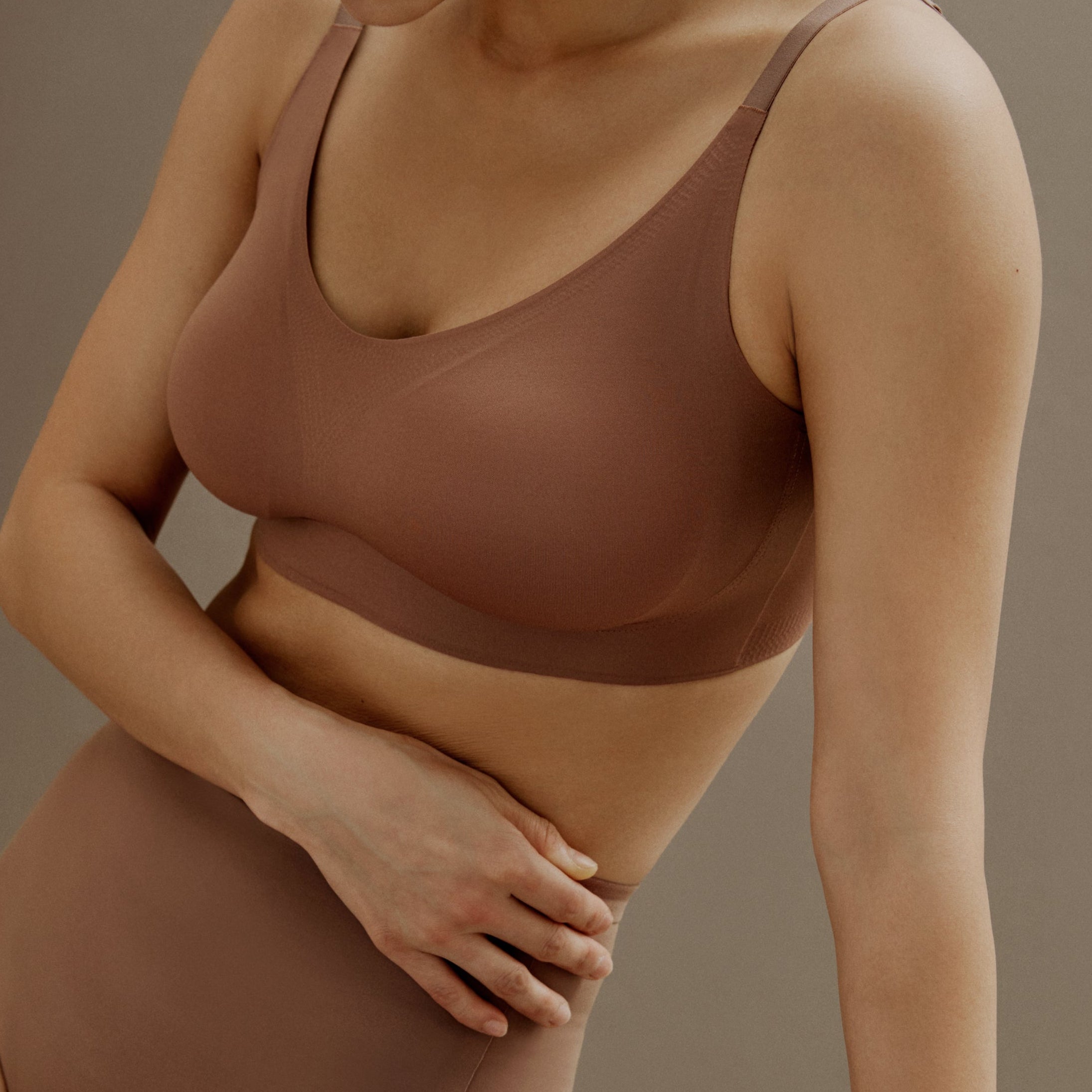 a woman wearing  set of brown color underwear