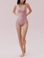 Front view of model wearing pink one piece swimsuit 