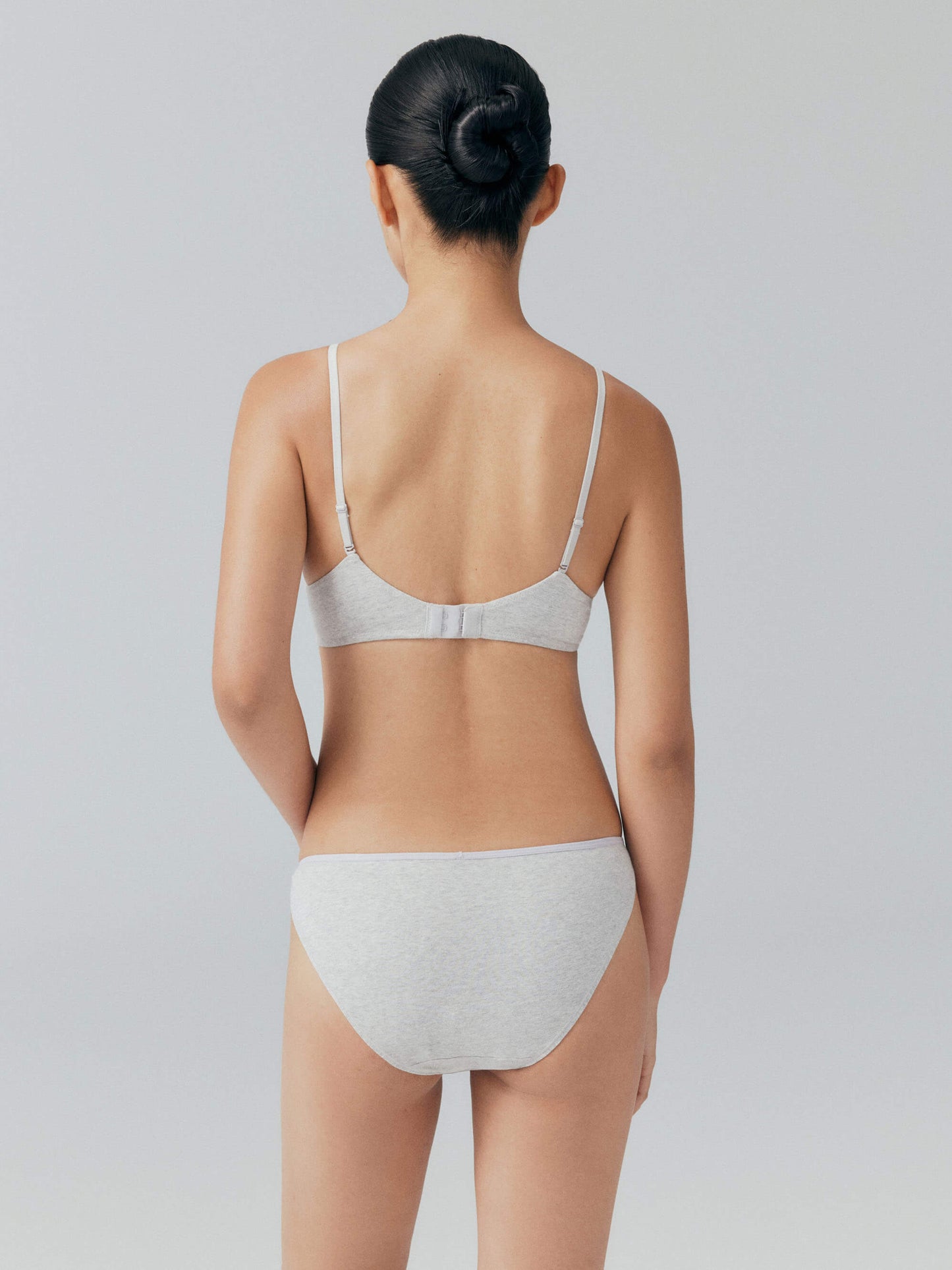 Back view of model wearing matching gray bra and brief set