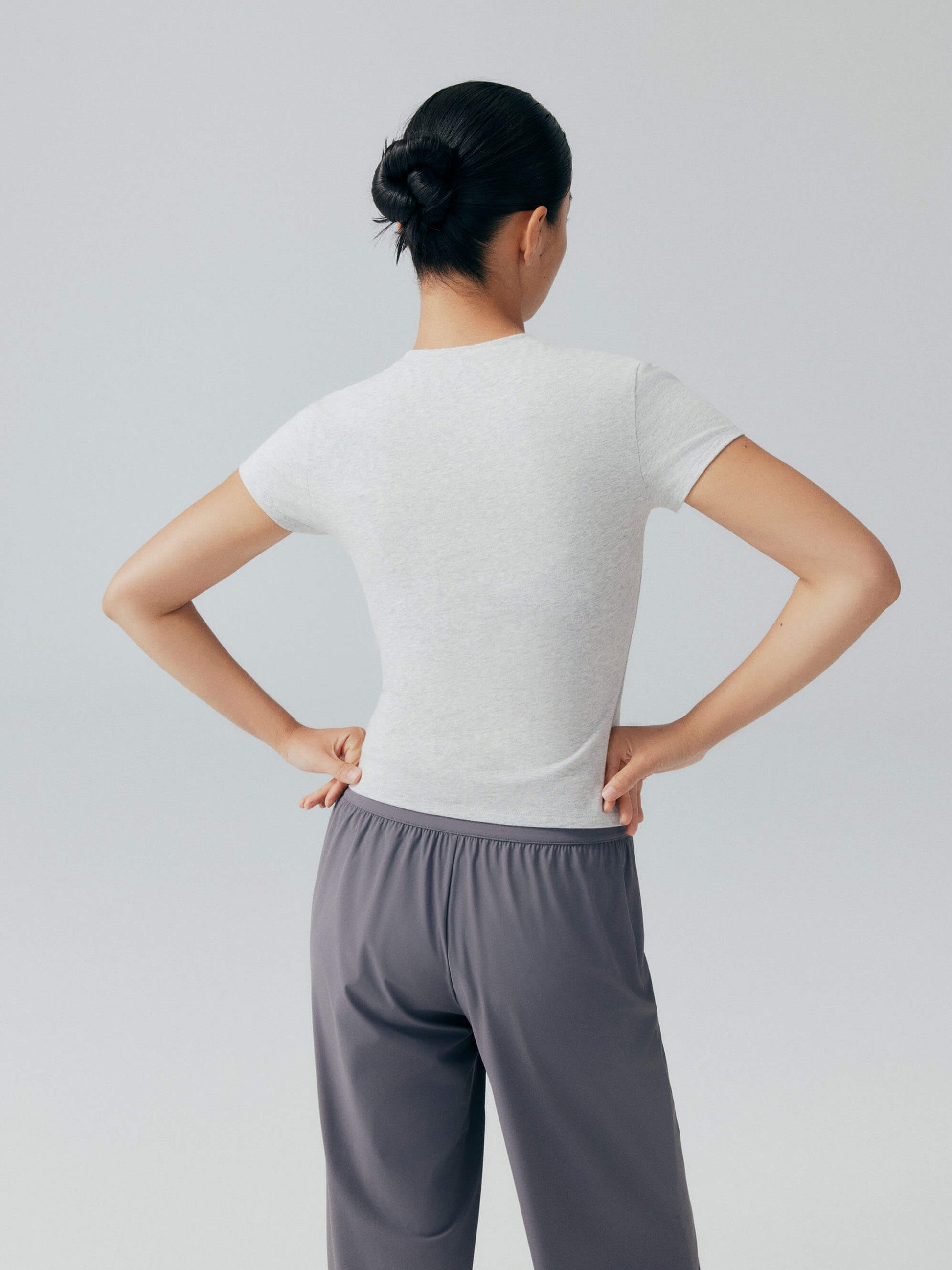 Back view of model wearing white tee.