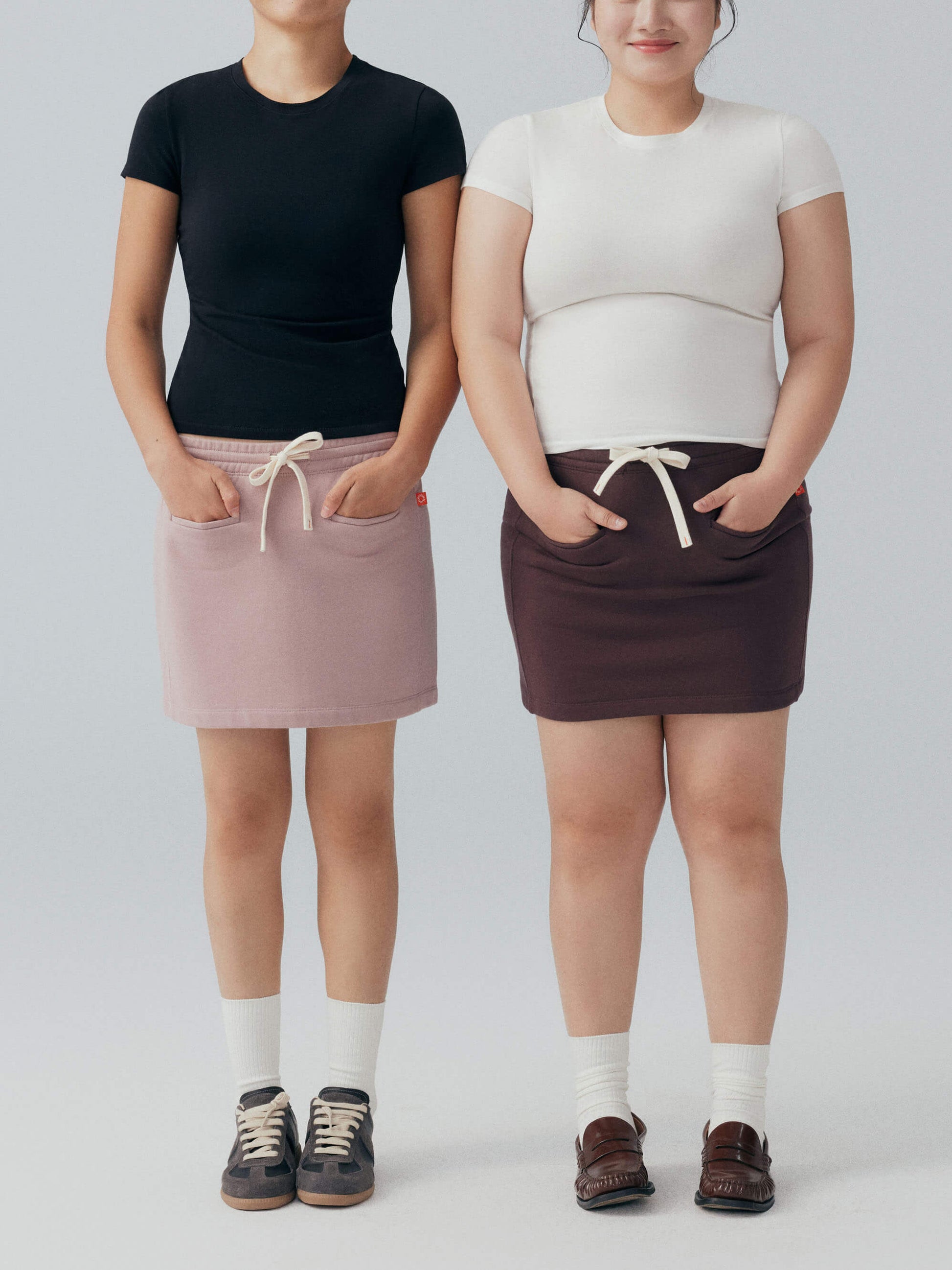 Two models wearing white and black tee.