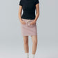 Model wearing black tee with pink skirt.