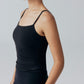 Side view of model wearing black camisole top.