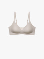 A seamless wireless bra in a light beige or cream color, shown from the front against a solid off-white background. Chateau Gray