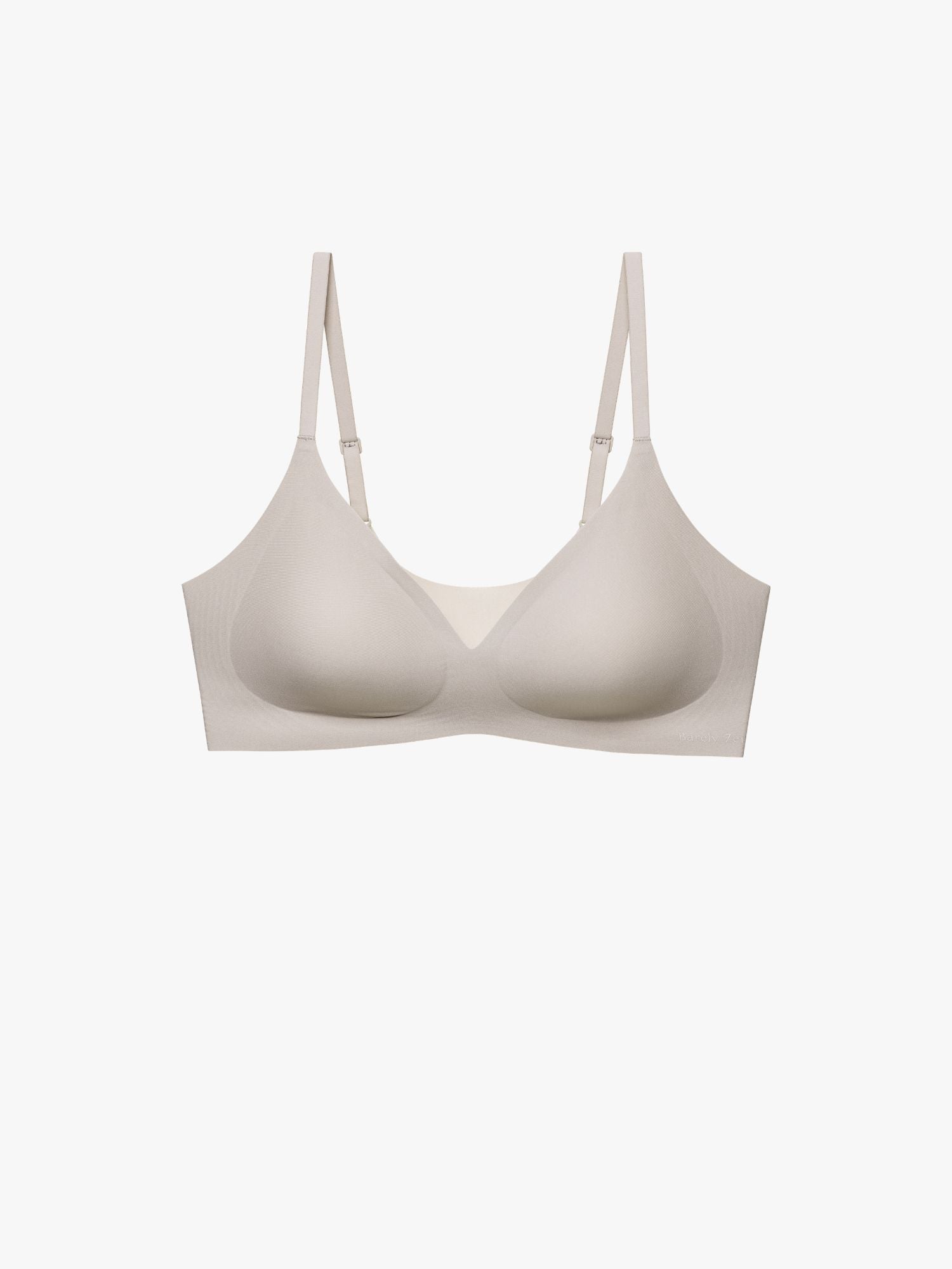 A seamless wireless bra in a light beige or cream color, shown from the front against a solid off-white background. Chateau Gray