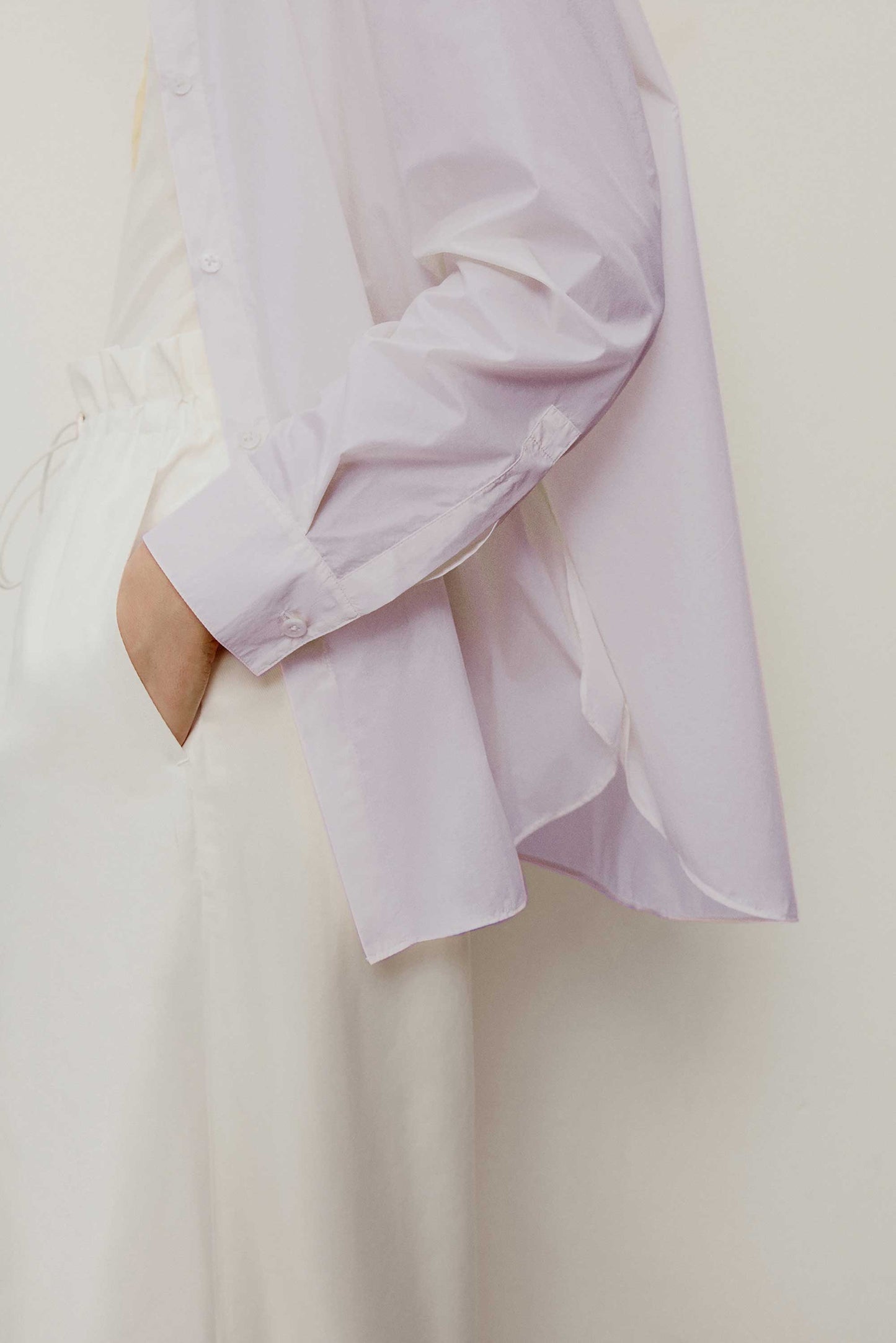 side detail of the light purple shirt. showing the long sleeve details 