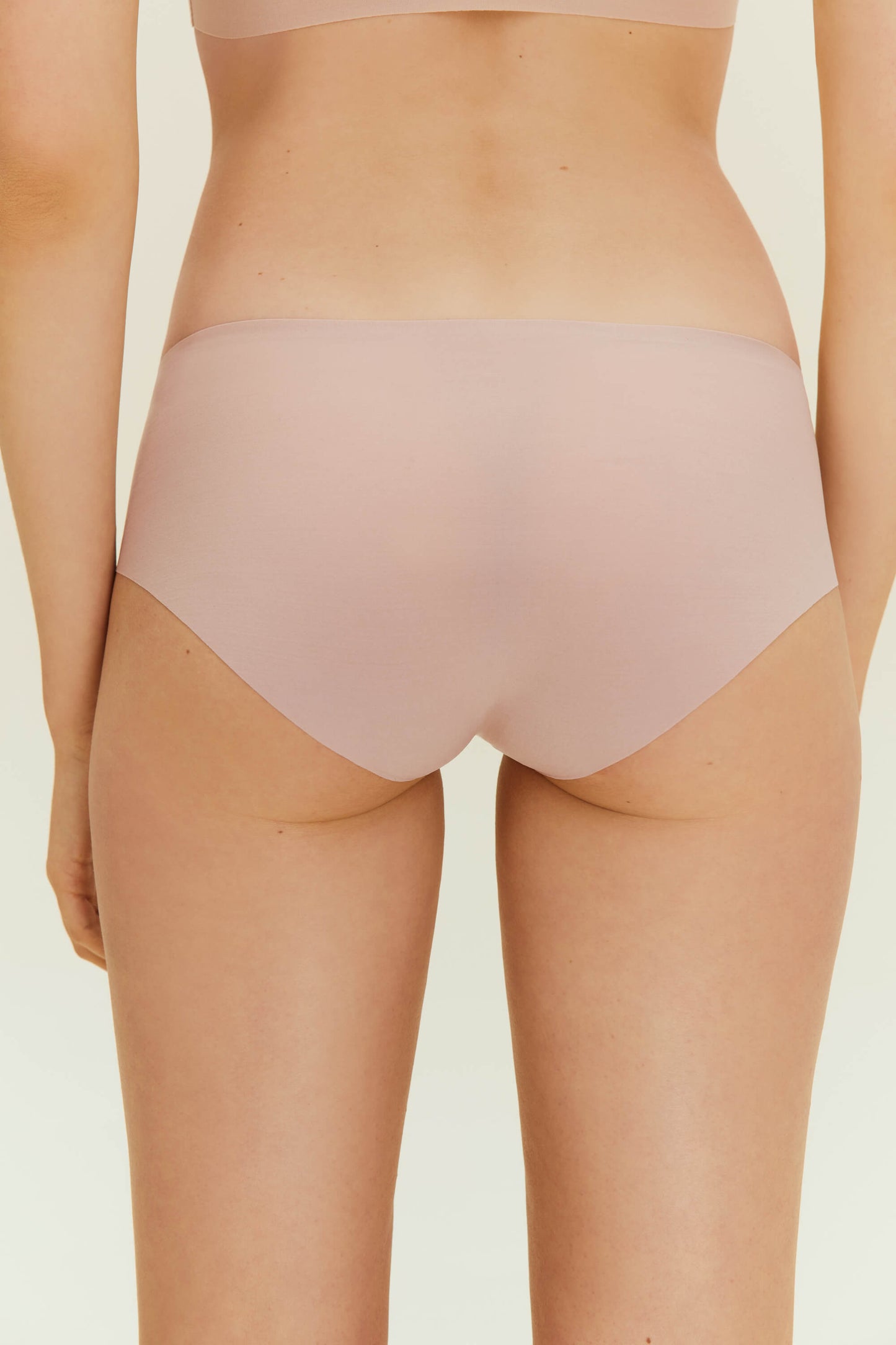 Back view of woman wearing beige underwear