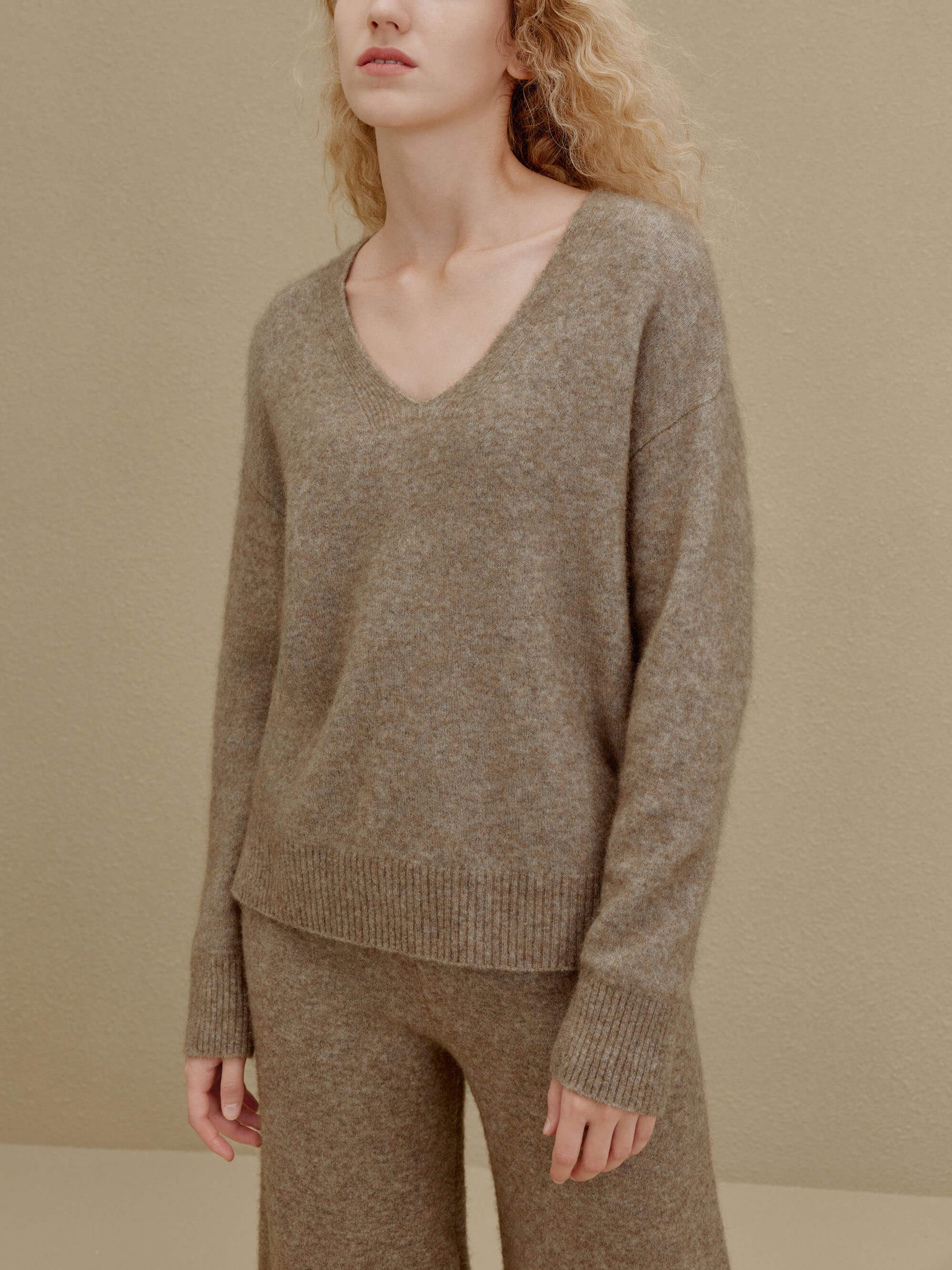 Woman wearing tan sweater