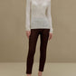 woman in white turtleneck sweater and brown pants