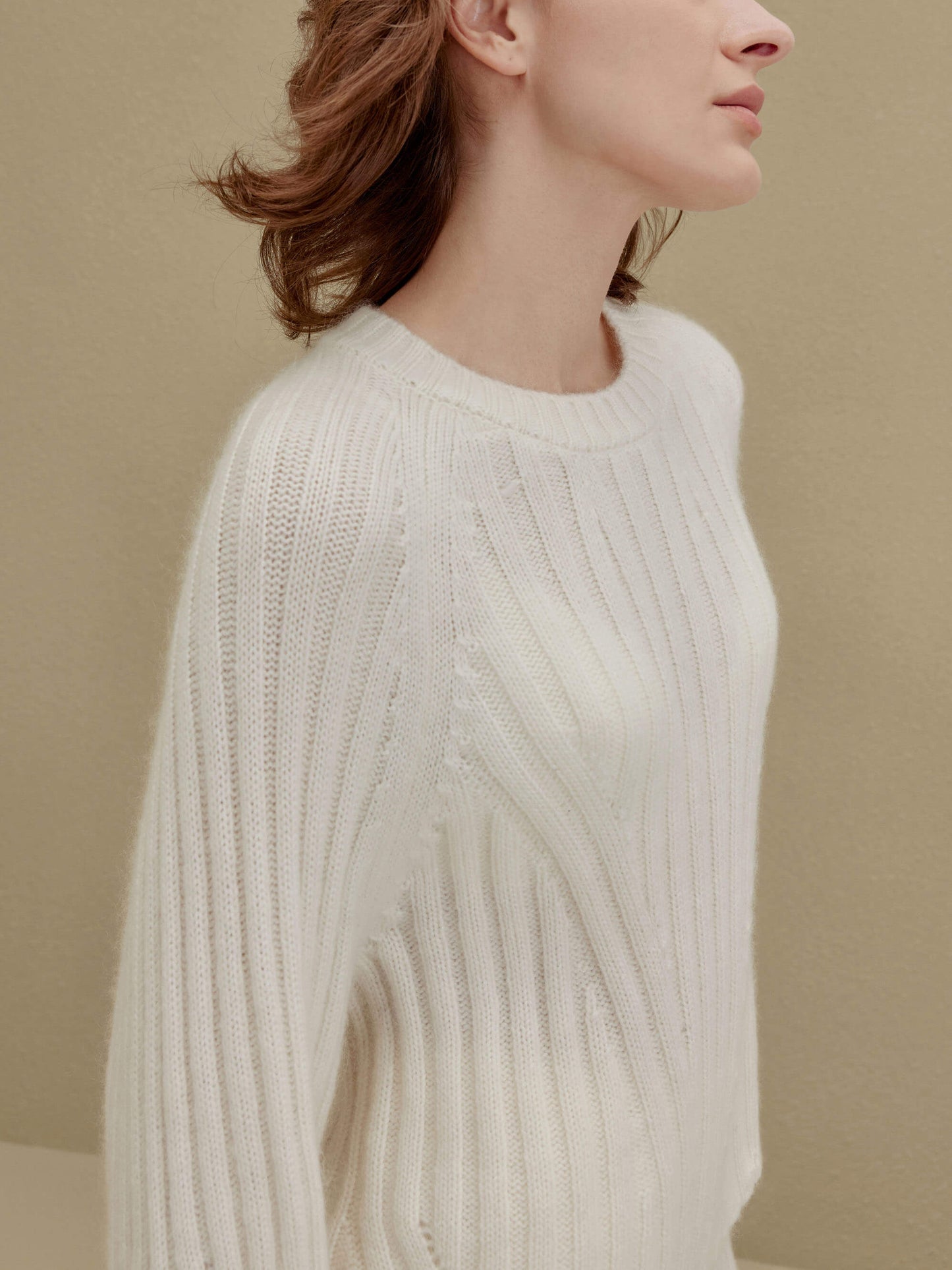 side of women in white ribbed sweater