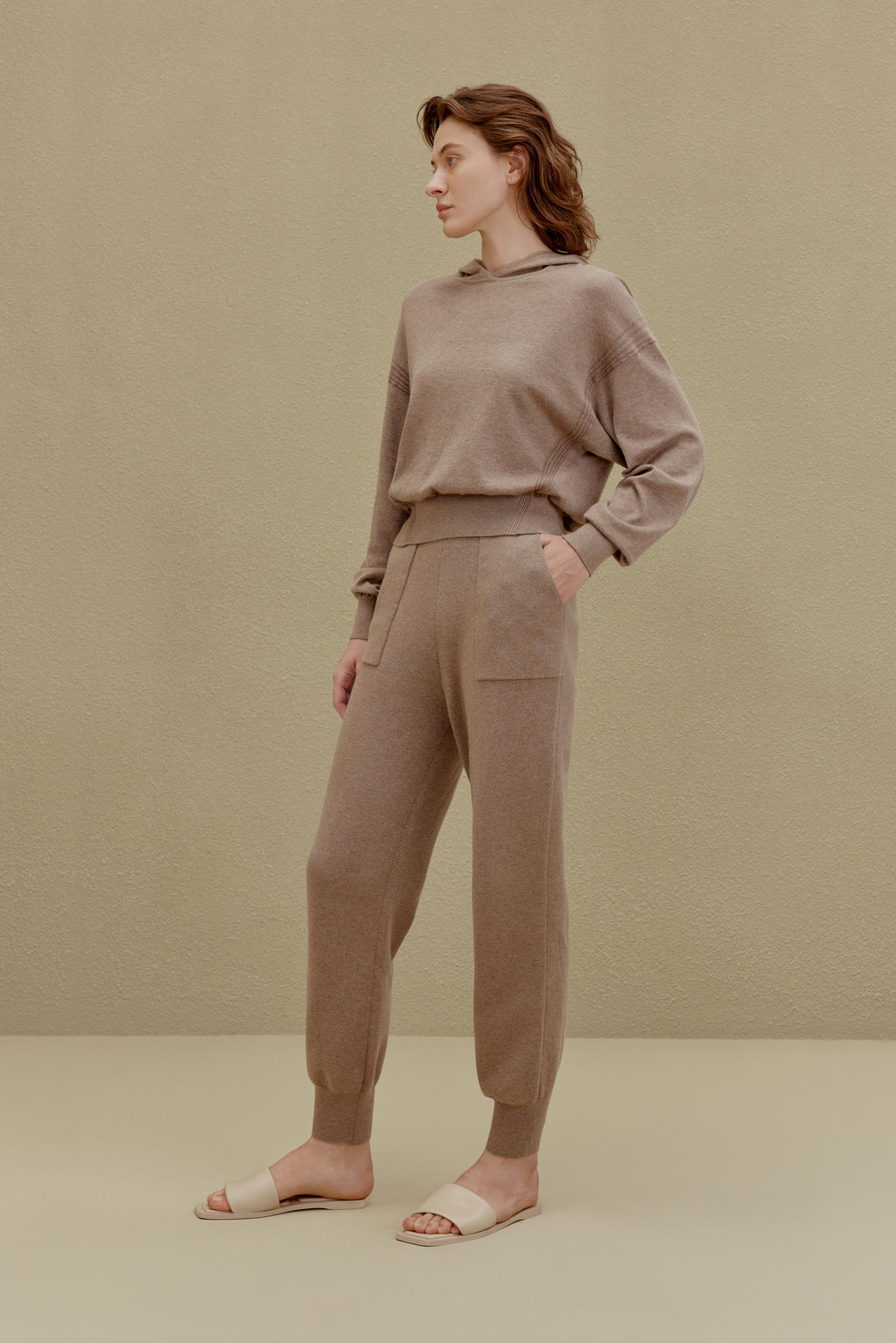A woman wearing a Camel hoodie and pants, front