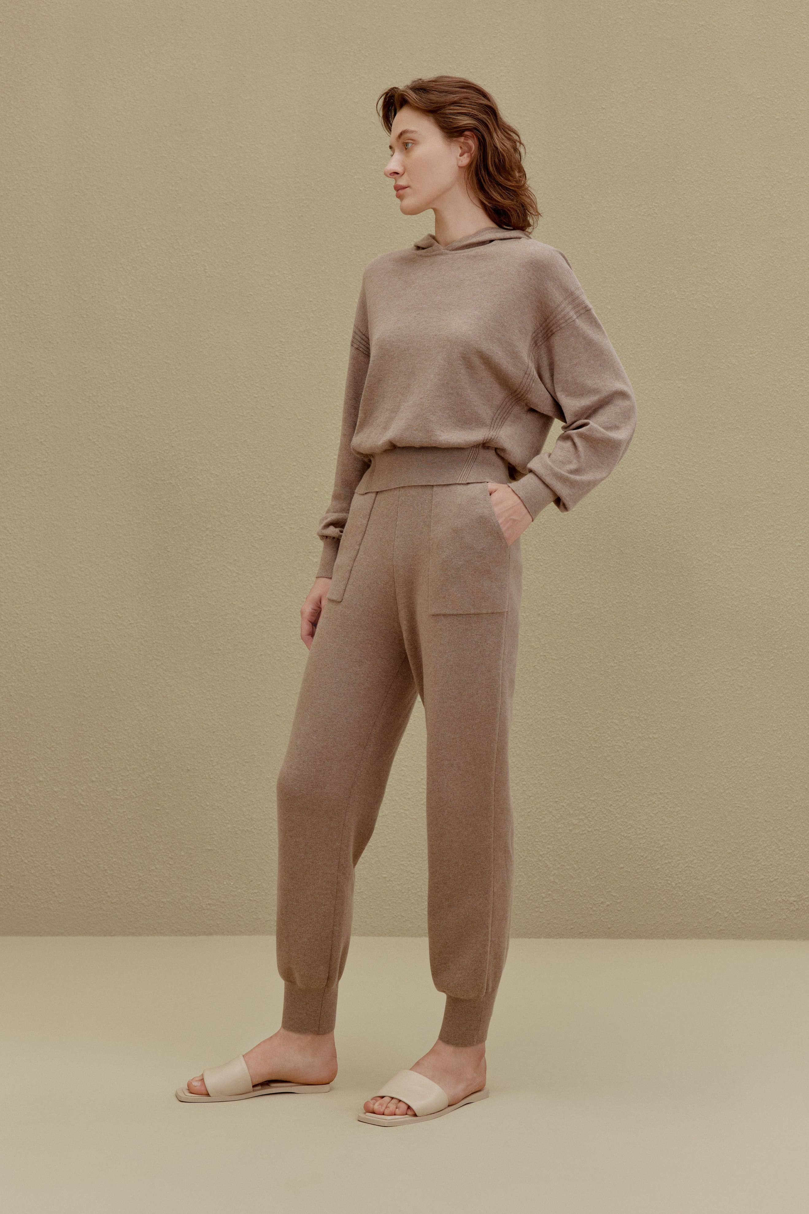 A woman wearing a Camel hoodie and pants, front