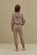 A woman wearing a Camel hoodie and pants, back