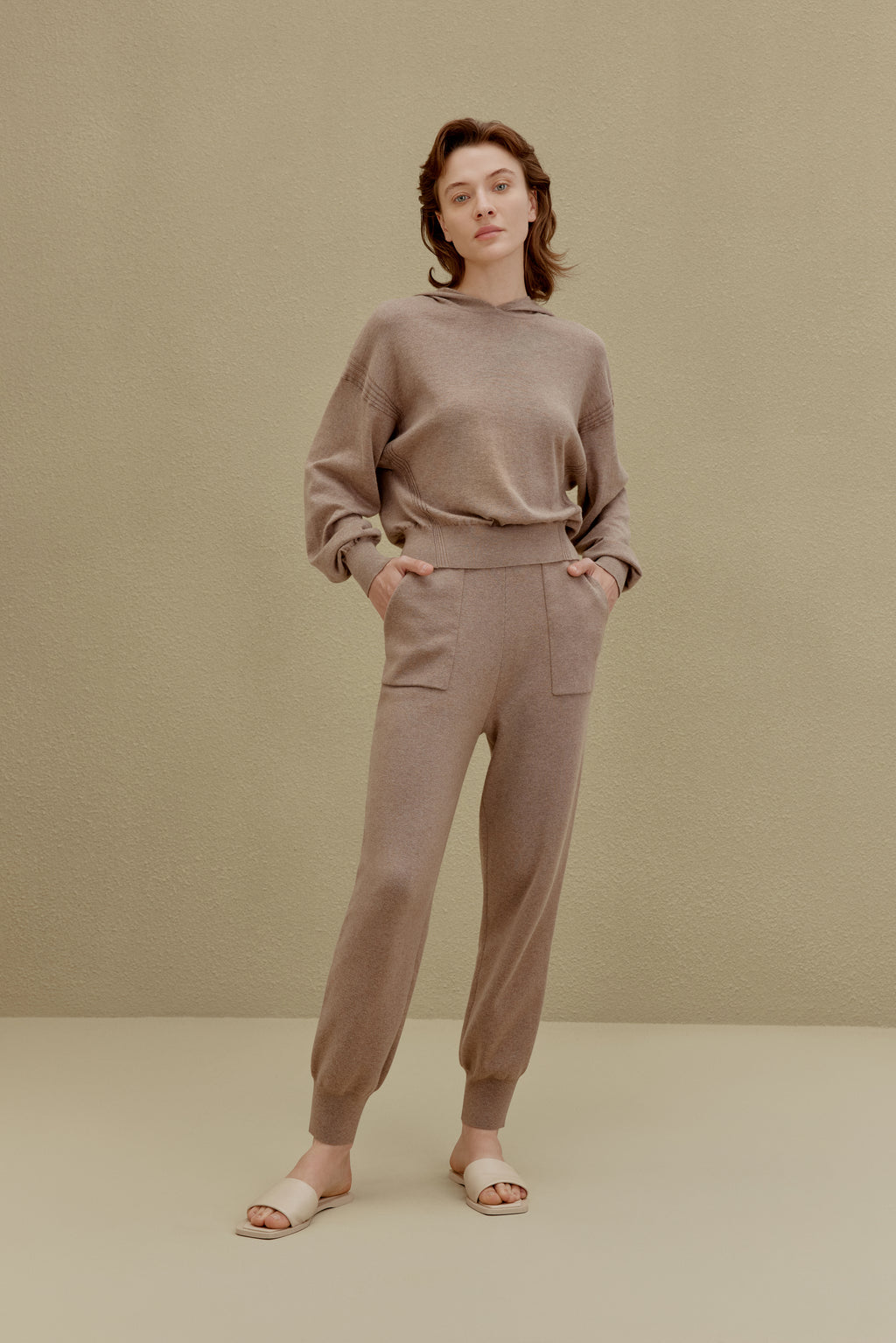 A woman wearing a Camel hoodie and pants, front