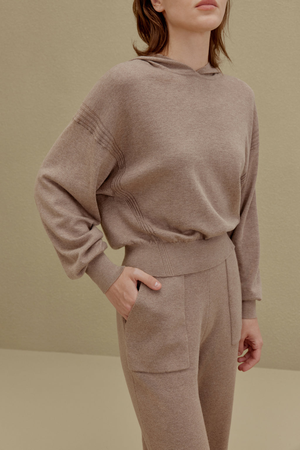 A woman wearing a Camel hoodie and pants