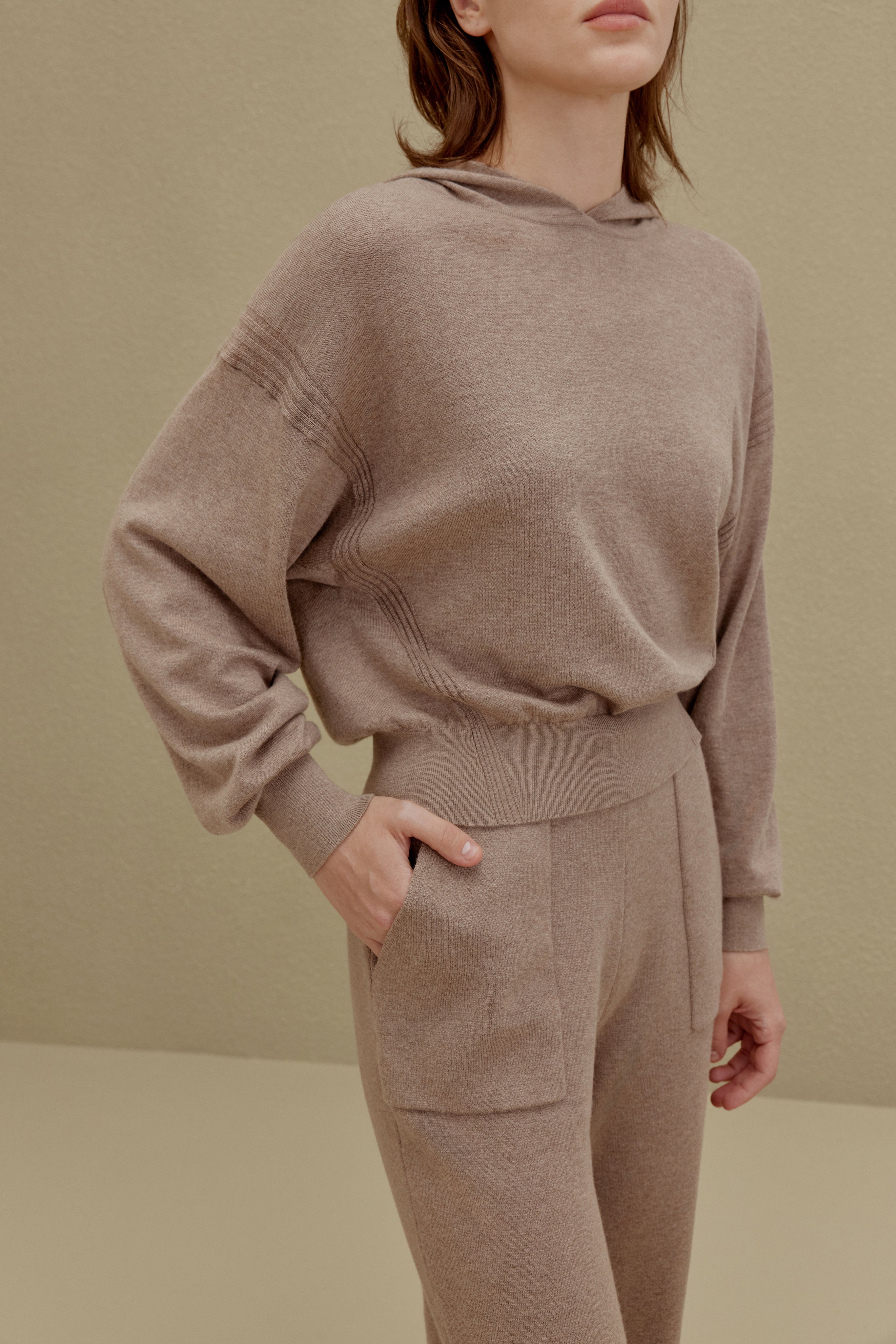 A woman wearing a Camel hoodie and pants