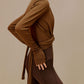 side of woman in brown wrap up cardigan