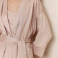 Woman in light pink long pajama robe