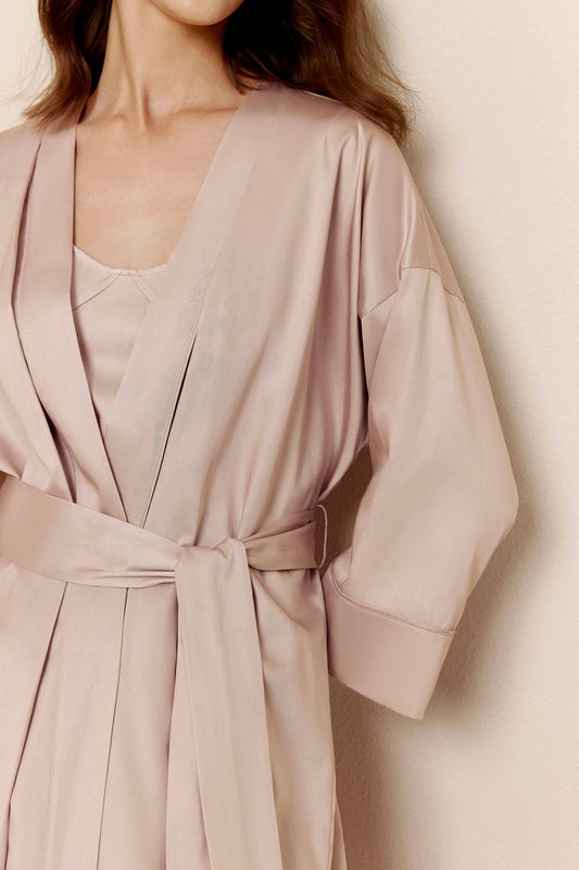 Woman in light pink long pajama robe