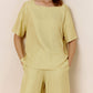 Front view of model wearing light green silk blend pajama top.